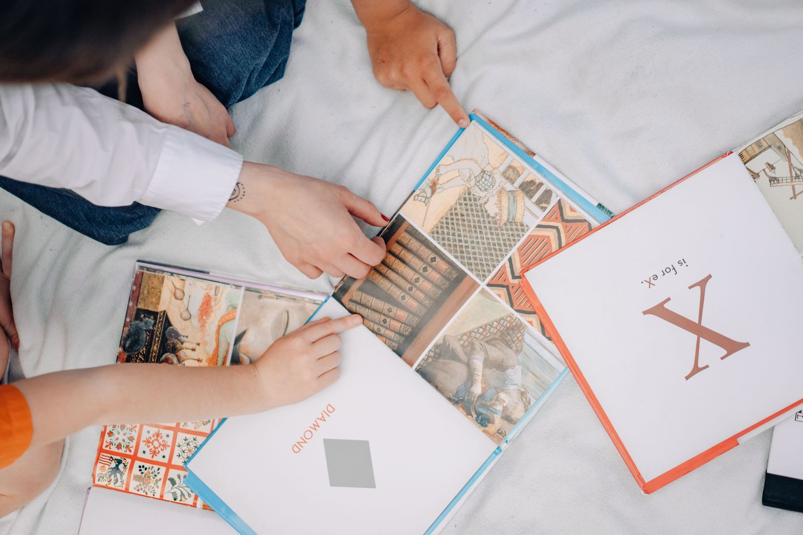 Adult and child reading picture books together