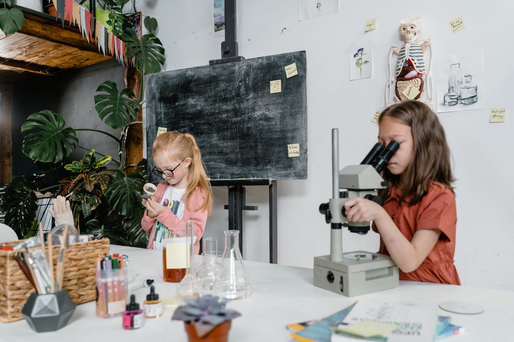 Children exploring science together with a microscope